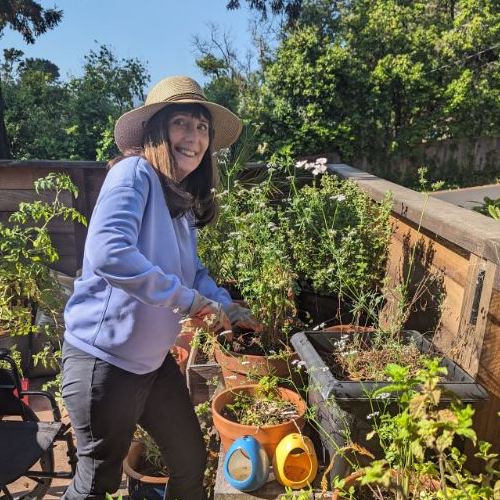 Deirdre Lehman gardening with a hat on